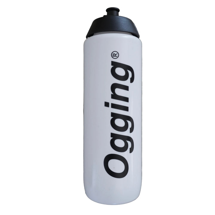 White water bottle with black cap and 'ogging' logo on a gray concrete surface